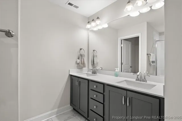 a view of walk in closet with clothes