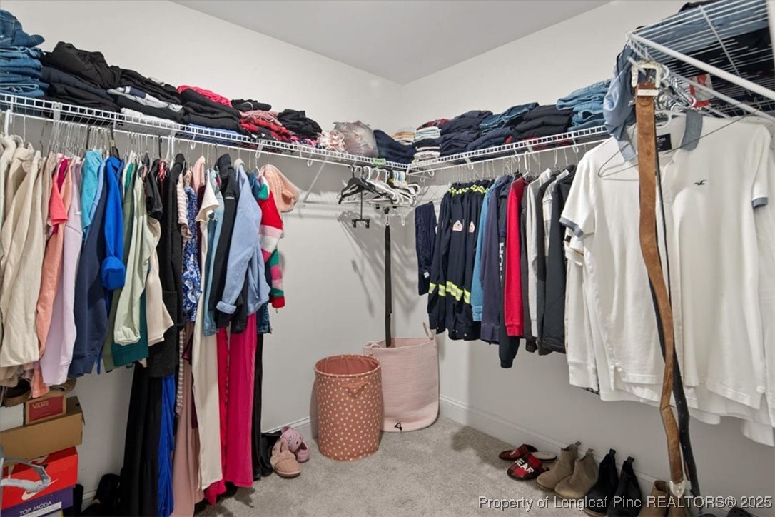 7840 Rufus Johnson Road Fayetteville, NC 28306 - Photo 48 of 50 a view of walk in closet with clothes