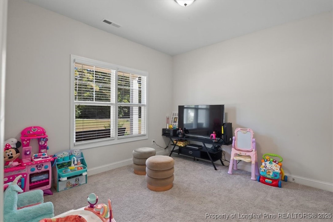 7840 Rufus Johnson Road Fayetteville, NC 28306 - Photo 10 of 50 a living room with furniture and a flat screen tv