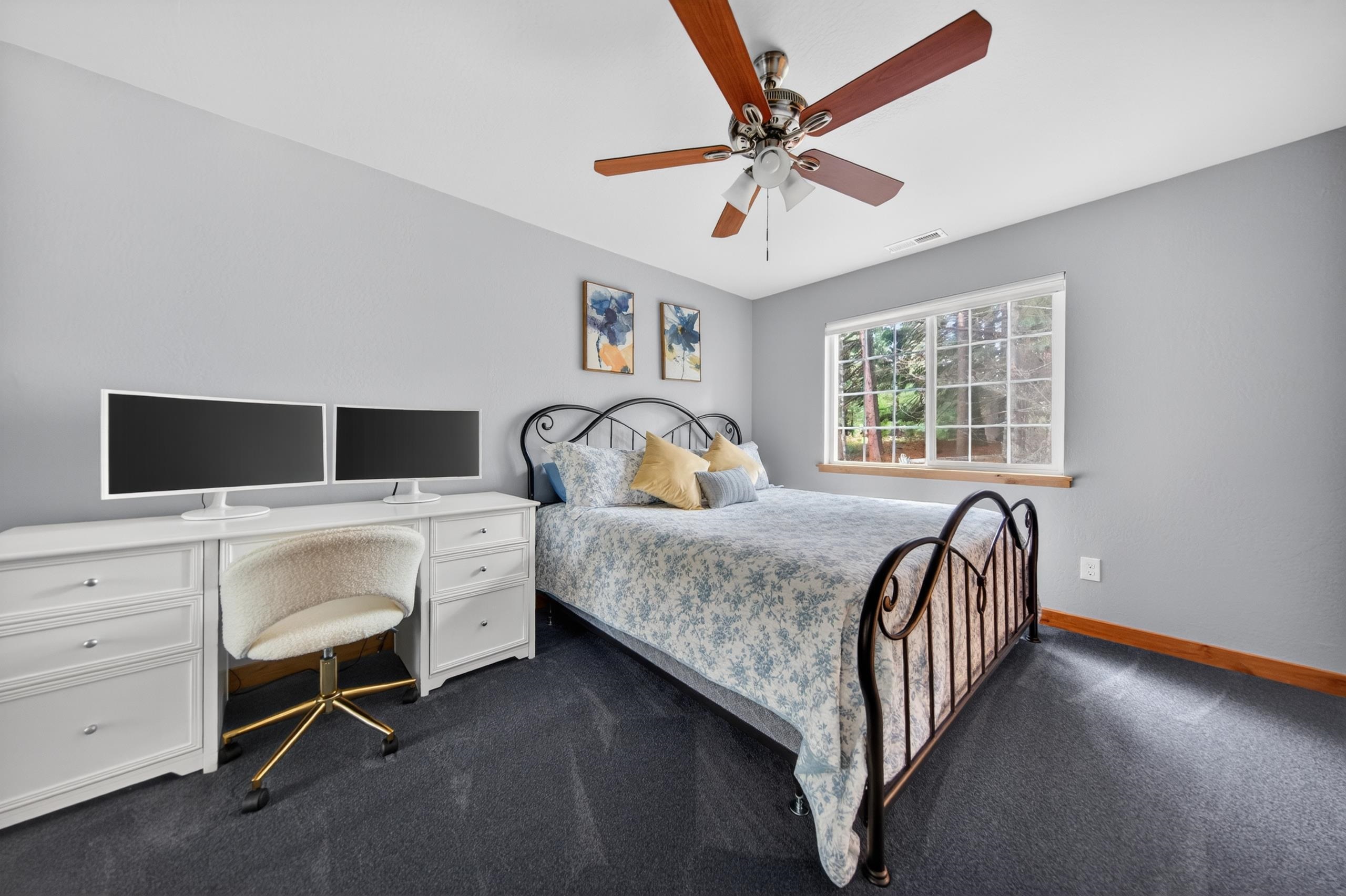 1220 Lynx Road Lake Almanor, CA 96137 - Photo 19 of 45 a bedroom with a bed and a chandelier