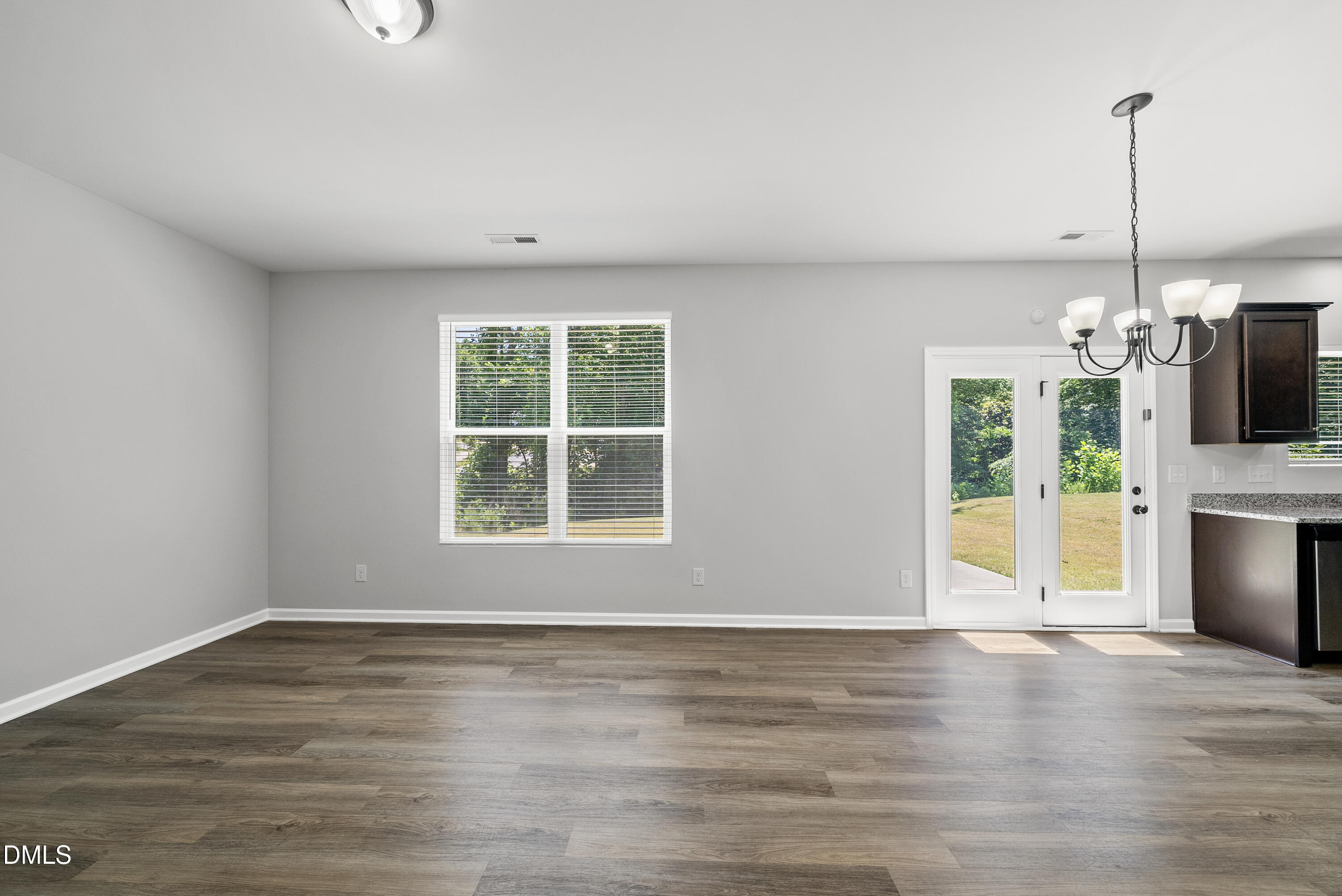 2816 Elsa Drive Raleigh, NC 27610 - Photo 13 of 35 a view of an empty room with a window and kitchen view