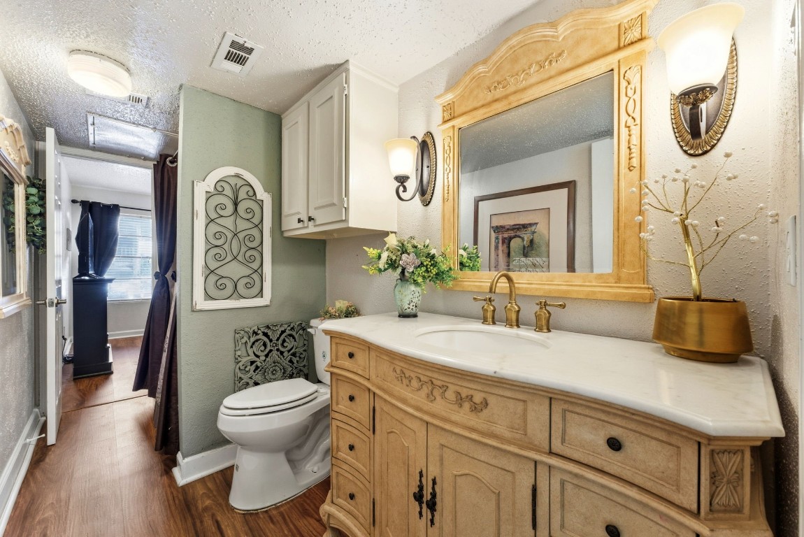 12900 Walden Road, Unit 219B Montgomery, TX 77356 - Photo 19 of 41 a bathroom with a granite countertop toilet sink and mirror