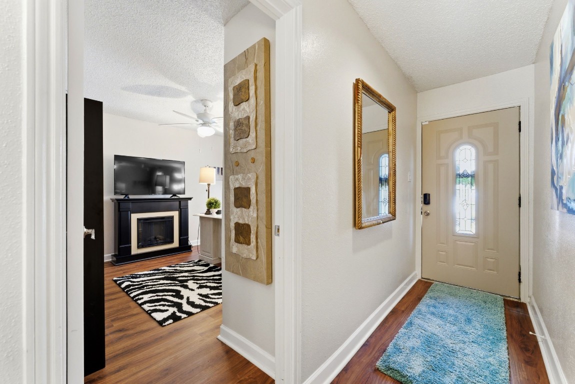 12900 Walden Road, Unit 219B Montgomery, TX 77356 - Photo 7 of 41 a view of a hallway with wooden floor and livingroom with furniture