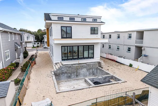 an aerial view of a house with a swimming pool