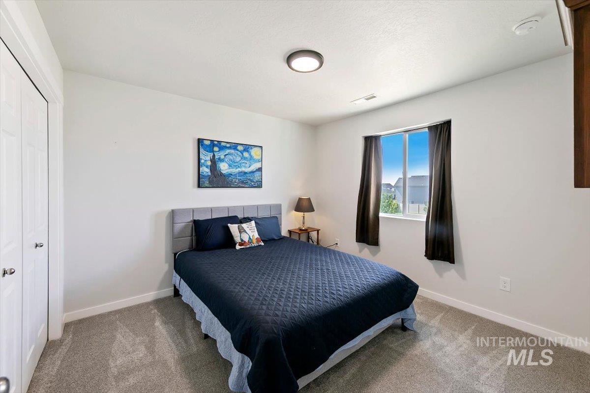 8575 South Foraker Way Kuna, ID 83634 - Photo 28 of 43 Bright and roomy second bedroom with bi-fold closet doors and a window