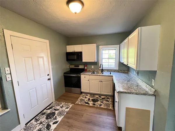 a kitchen with a sink stove and refrigerator