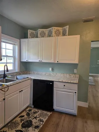 a kitchen with a sink and cabinets