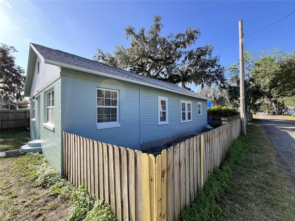 a view of a house with wooden fence