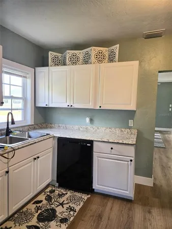 a kitchen with a sink stove and cabinets