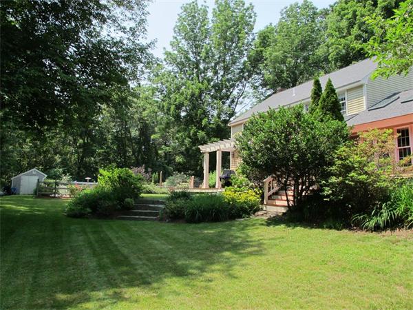 39 Highland Road Boxford, MA 01921 - Photo 22 of 30 a front view of a house with a garden