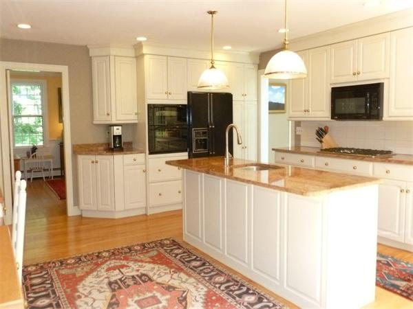39 Highland Road Boxford, MA 01921 - Photo 7 of 30 a view of a kitchen with kitchen island granite countertop a sink and a stove