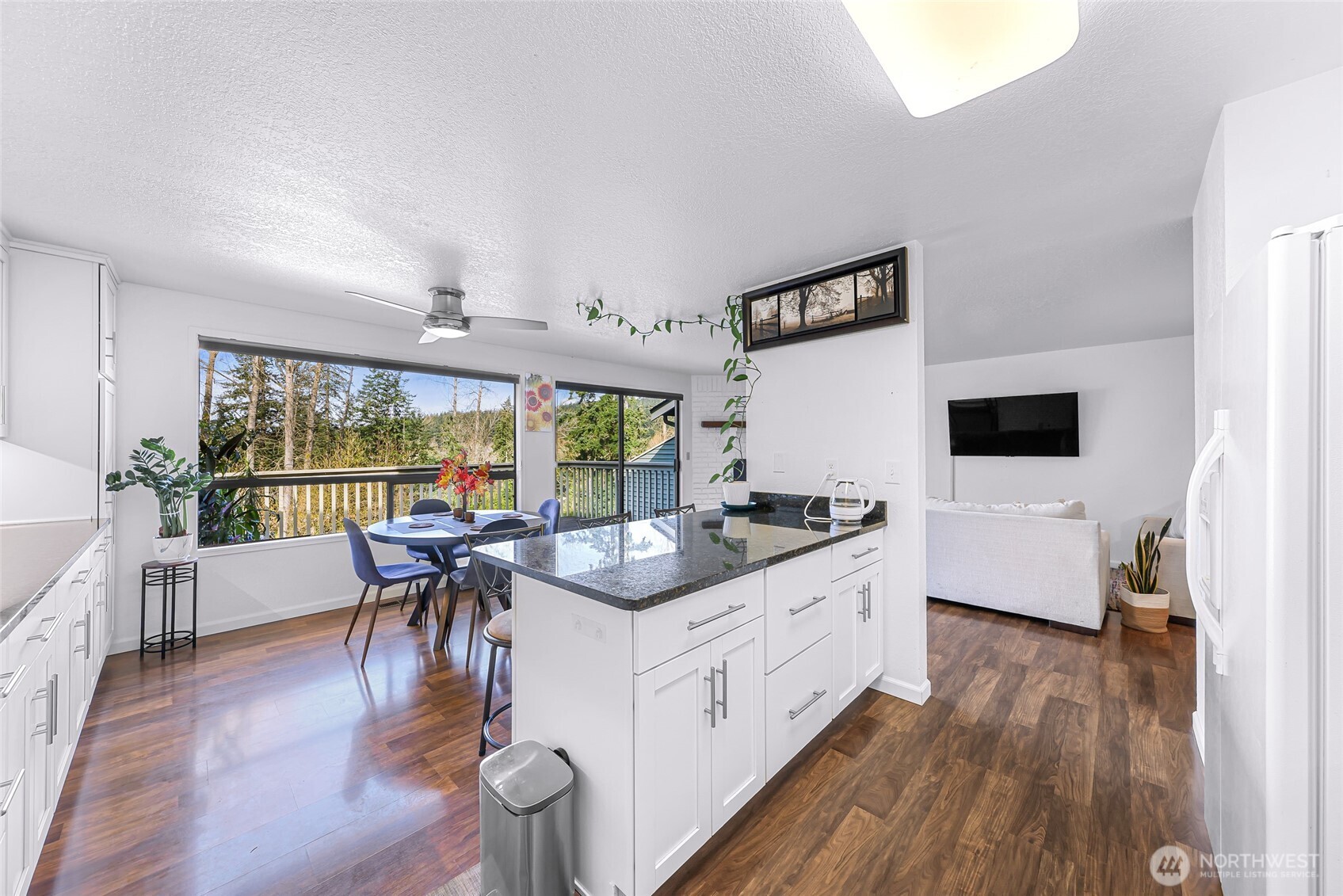 3500 Ridgemont Way, Unit 3 Bellingham, WA 98229 - Photo 13 of 39 a living room with furniture a flat screen tv and a floor to ceiling window
