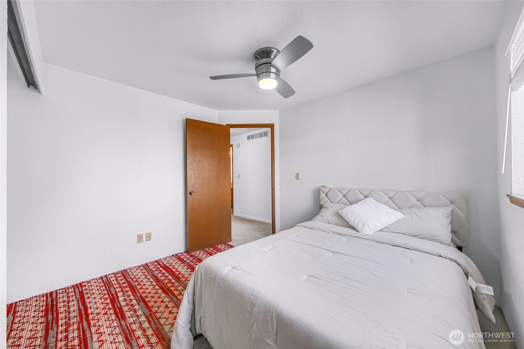 3500 Ridgemont Way, Unit 3 Bellingham, WA 98229 - Photo 20 of 39 a bedroom with a bed and a chandelier