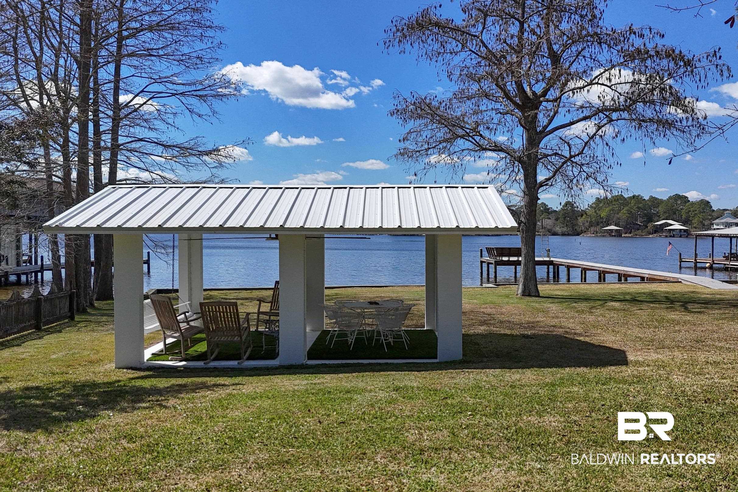 9459 Soldier Creek Road Lillian, AL 36549 - Photo 43 of 54 View of dock with a water view, a gazebo, and a yard