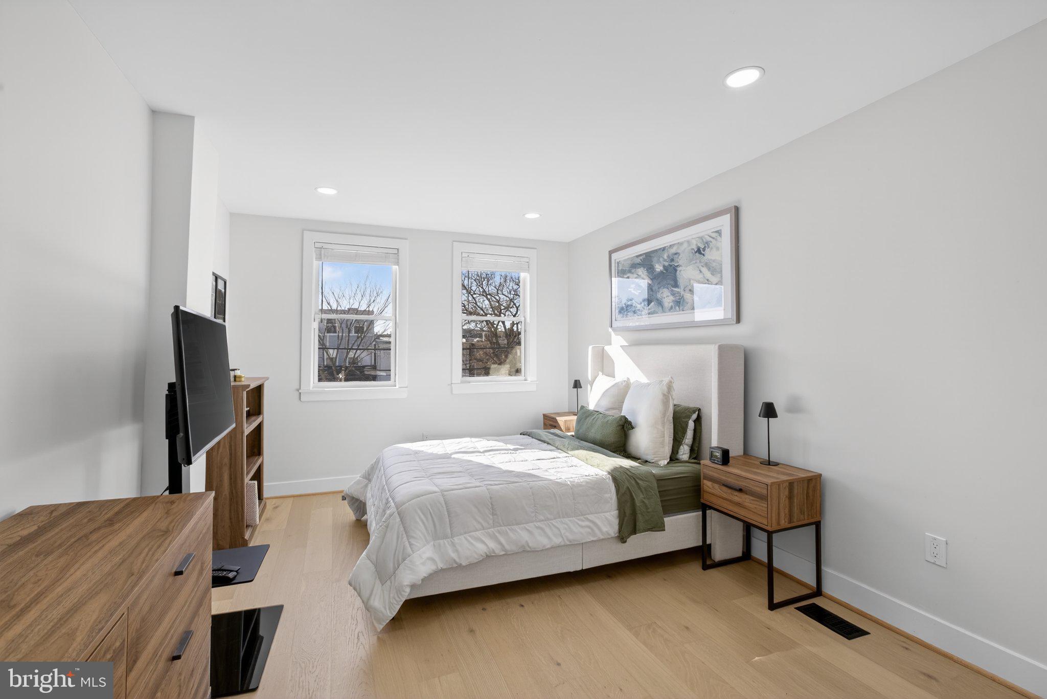 2015 Gales Street Northeast Washington, DC 20002 - Photo 6 of 10 a bedroom with a bed and a flat screen tv