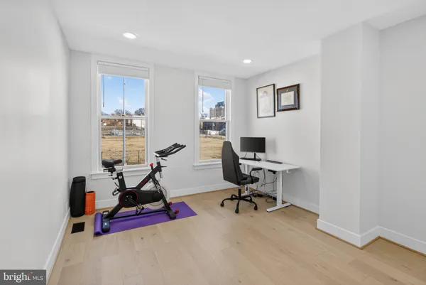 a view of a workspace with furniture and a window