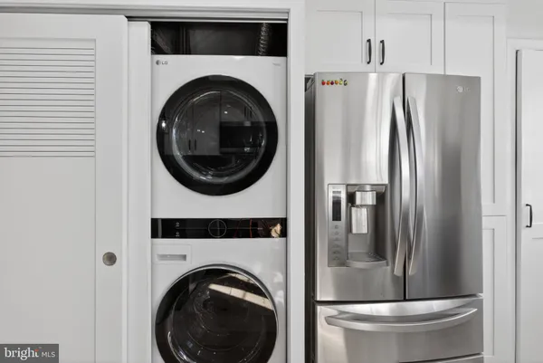 a view of a refrigerator and washer in a kitchen