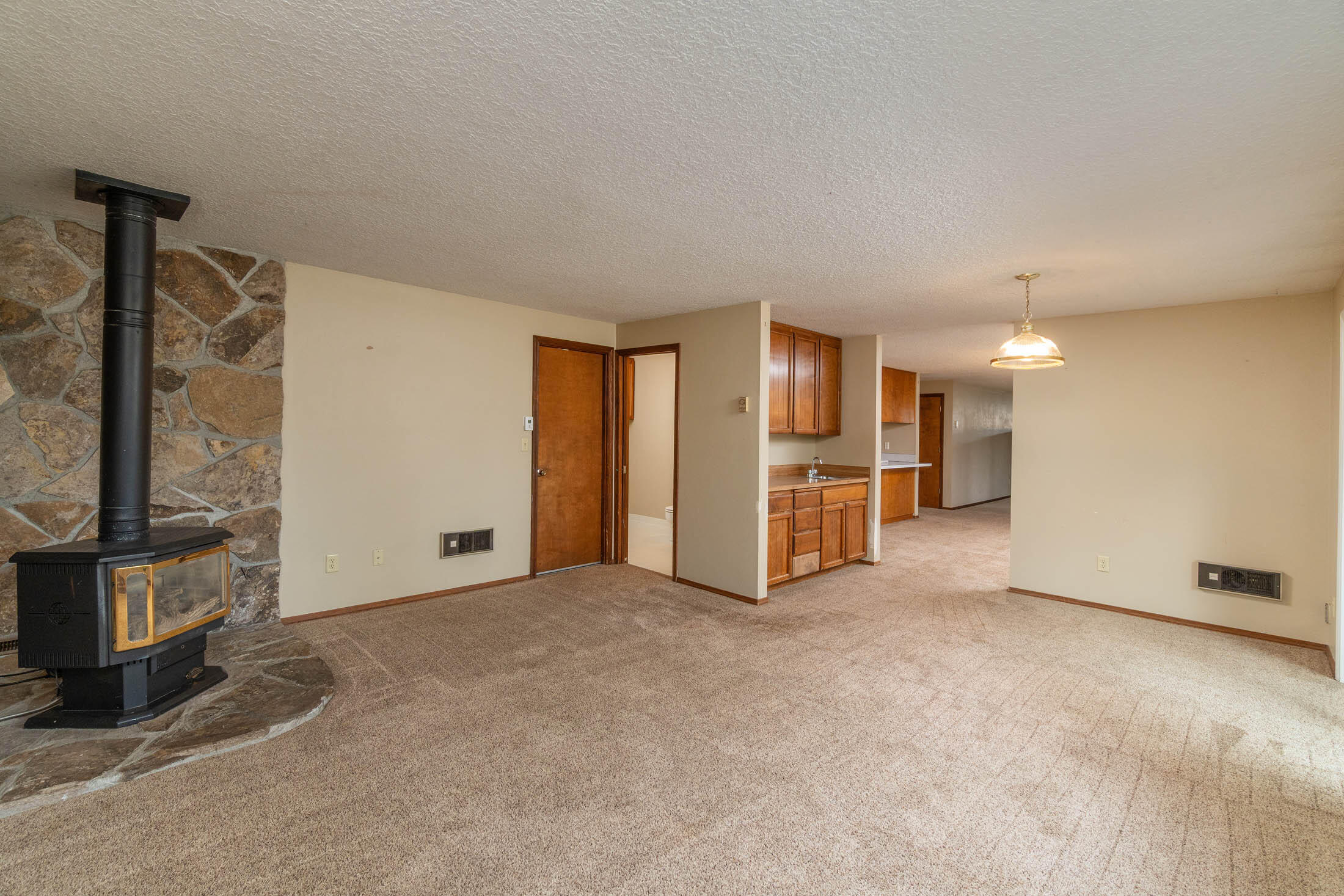 20316 Donkey Sled Road Bend, OR 97702 - Photo 10 of 50 a view of an empty room with a fireplace