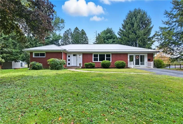 a view of house that has a yard