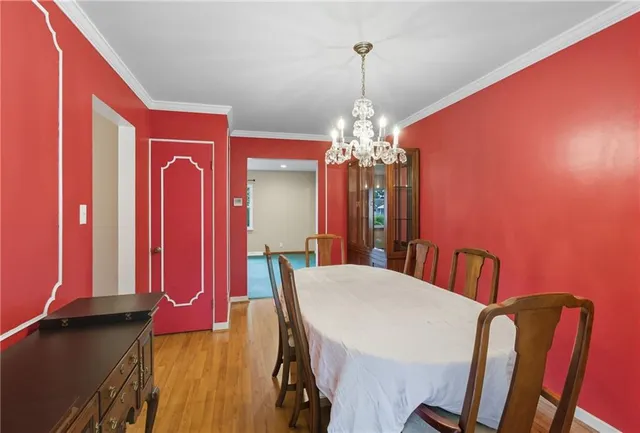 a view of a dining room with furniture and chandelier