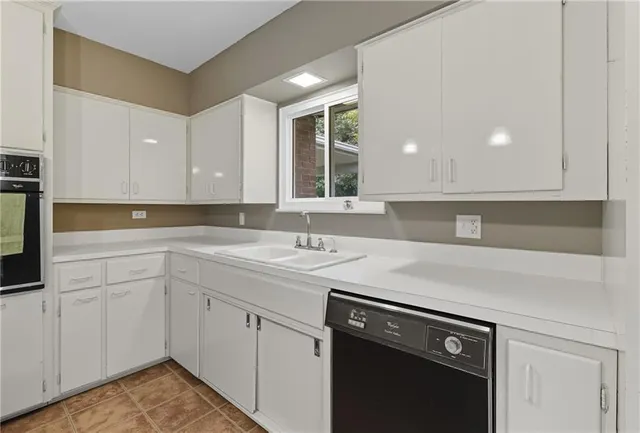 a kitchen with a sink and cabinets