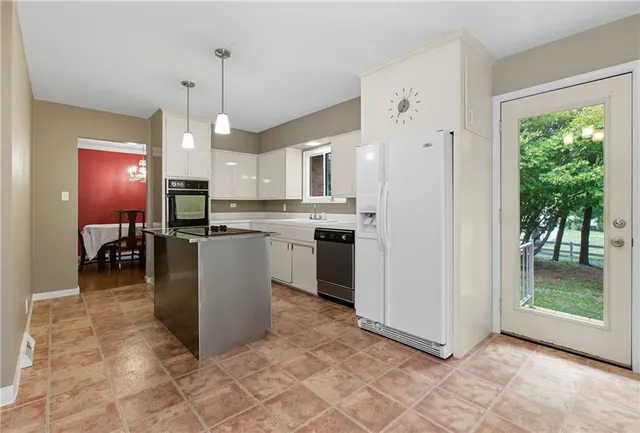 a open kitchen with cabinets and stainless steel appliances