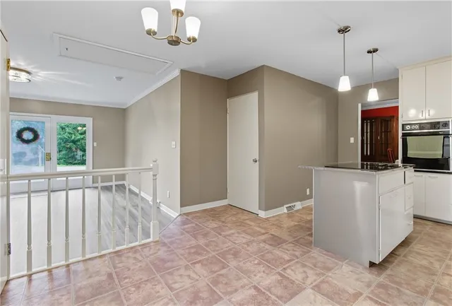 a view of kitchen with microwave and refrigerator