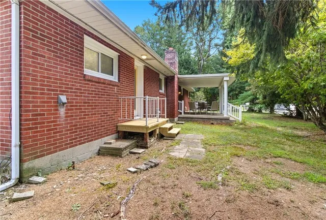 a view of house that has a yard