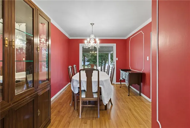 a dining room with furniture window and wooden floor