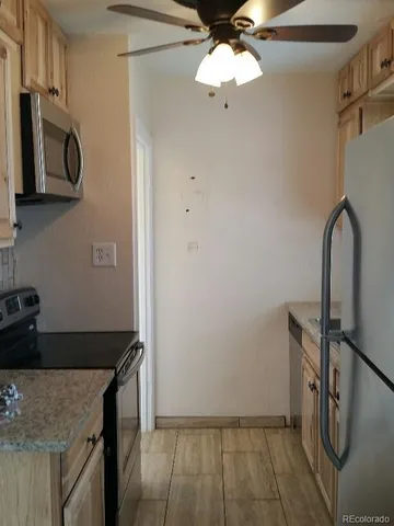 a kitchen with a refrigerator and a sink