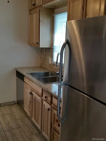 a kitchen with a sink and a refrigerator