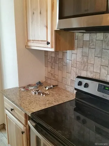 a stove top oven sitting inside of a kitchen