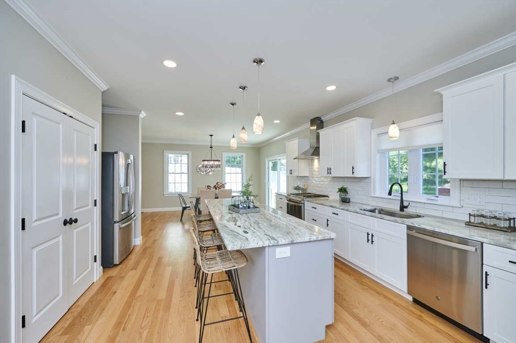 60 Peach Orchard Road Burlington, MA 01803 - Photo 14 of 42 a open kitchen with stainless steel appliances granite countertop a lot of counter space and wooden floors