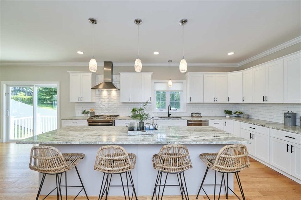 60 Peach Orchard Road Burlington, MA 01803 - Photo 15 of 42 a kitchen with granite countertop white cabinets and window