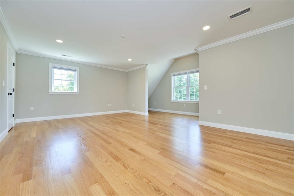 60 Peach Orchard Road Burlington, MA 01803 - Photo 21 of 42 an empty room with wooden floor and windows