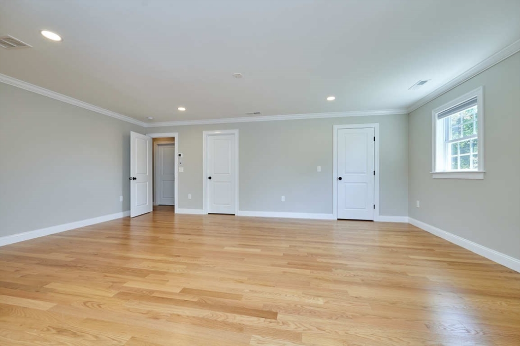 60 Peach Orchard Road Burlington, MA 01803 - Photo 22 of 42 a view of an empty room with wooden floor and window