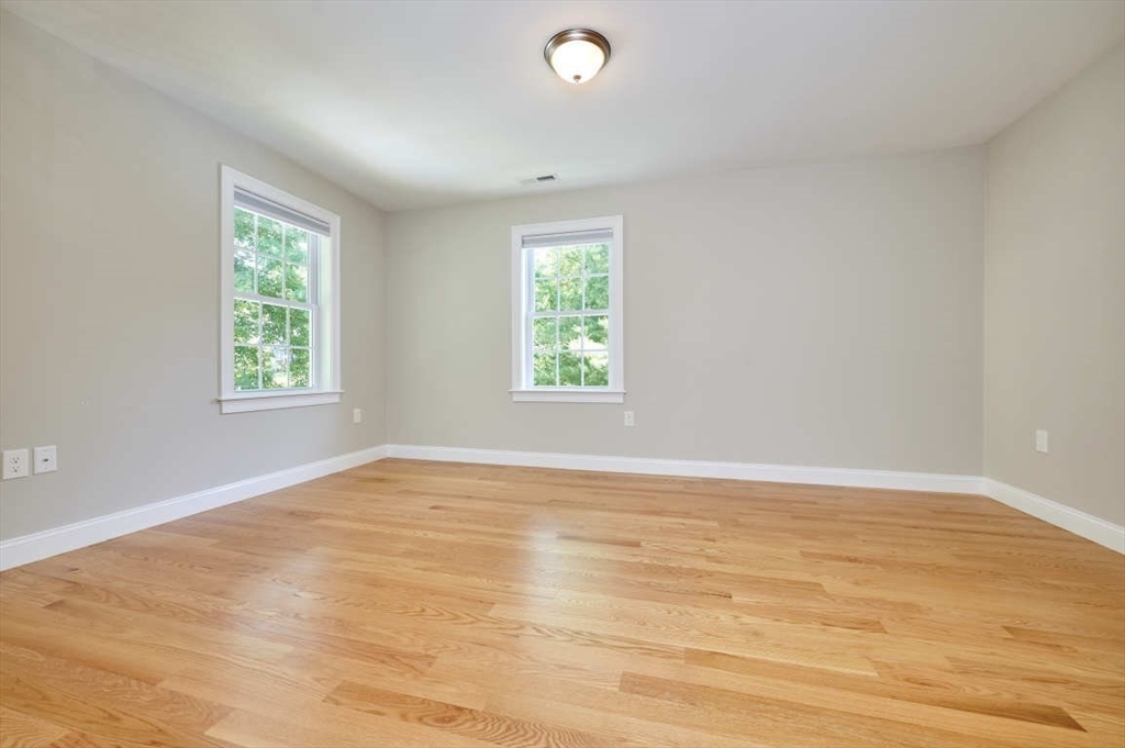 60 Peach Orchard Road Burlington, MA 01803 - Photo 25 of 42 wooden floor in an empty room with window