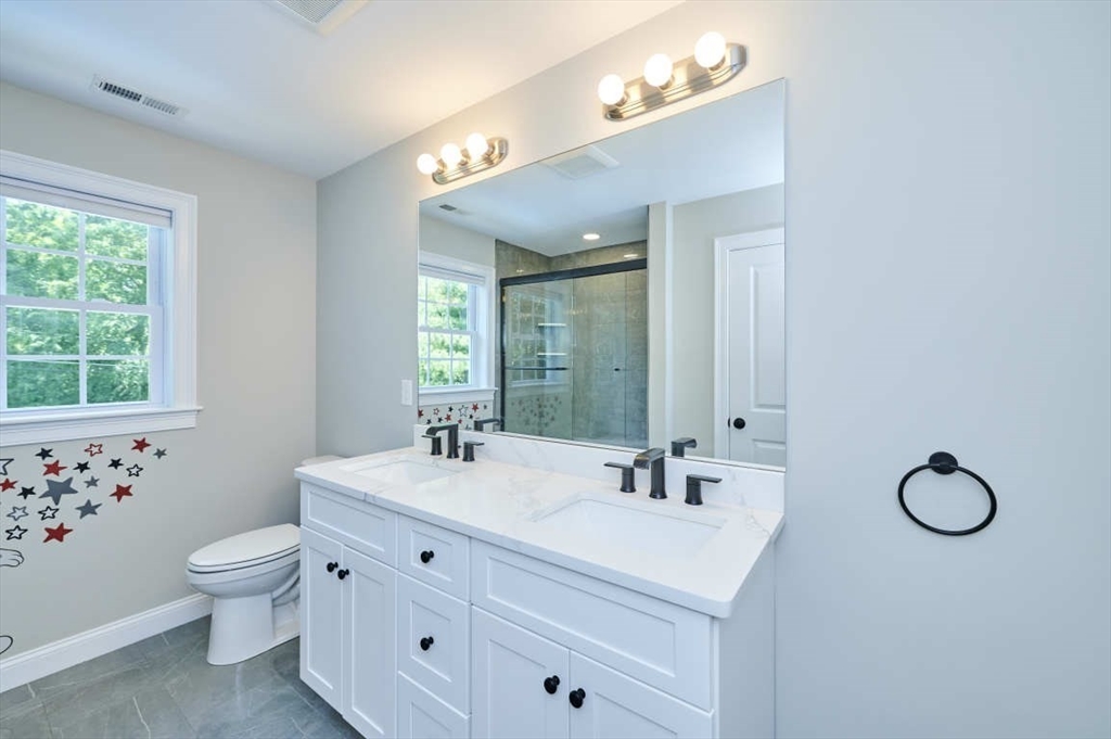 60 Peach Orchard Road Burlington, MA 01803 - Photo 32 of 42 a bathroom with a double vanity sink toilet and a mirror