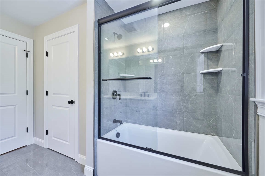 60 Peach Orchard Road Burlington, MA 01803 - Photo 33 of 42 a bathroom with a bathtub and a shower
