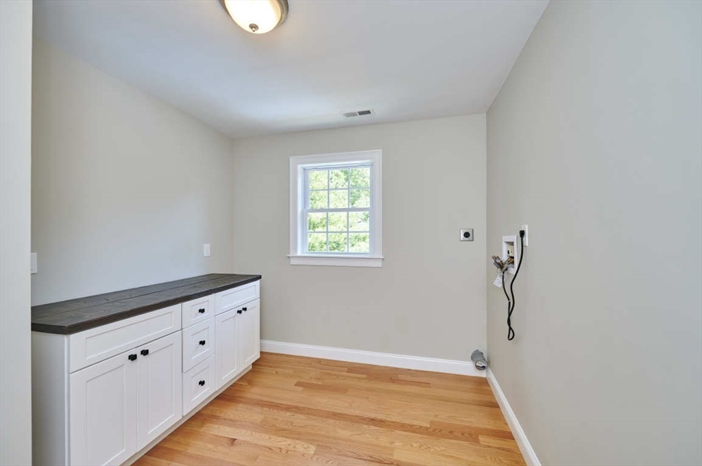 60 Peach Orchard Road Burlington, MA 01803 - Photo 34 of 42 a view of an empty room with wooden floor and a window