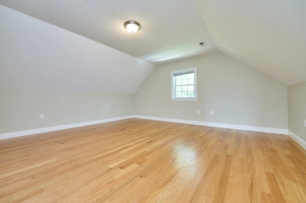 60 Peach Orchard Road Burlington, MA 01803 - Photo 37 of 42 an empty room with wooden floor and windows