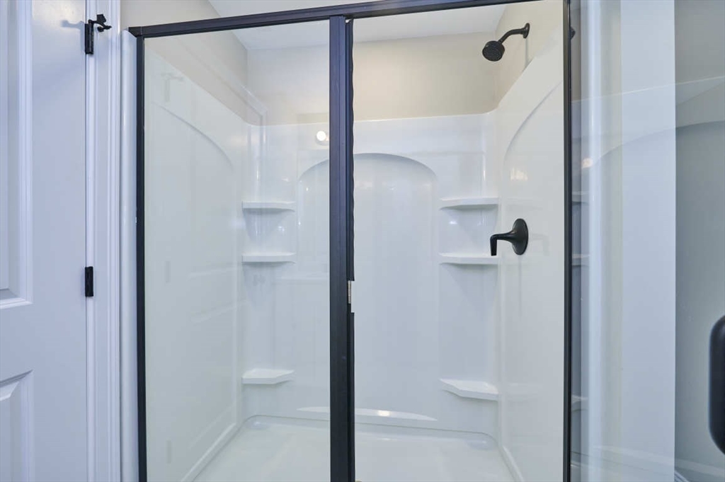 60 Peach Orchard Road Burlington, MA 01803 - Photo 39 of 42 a bathroom with a glass shower door and mirror