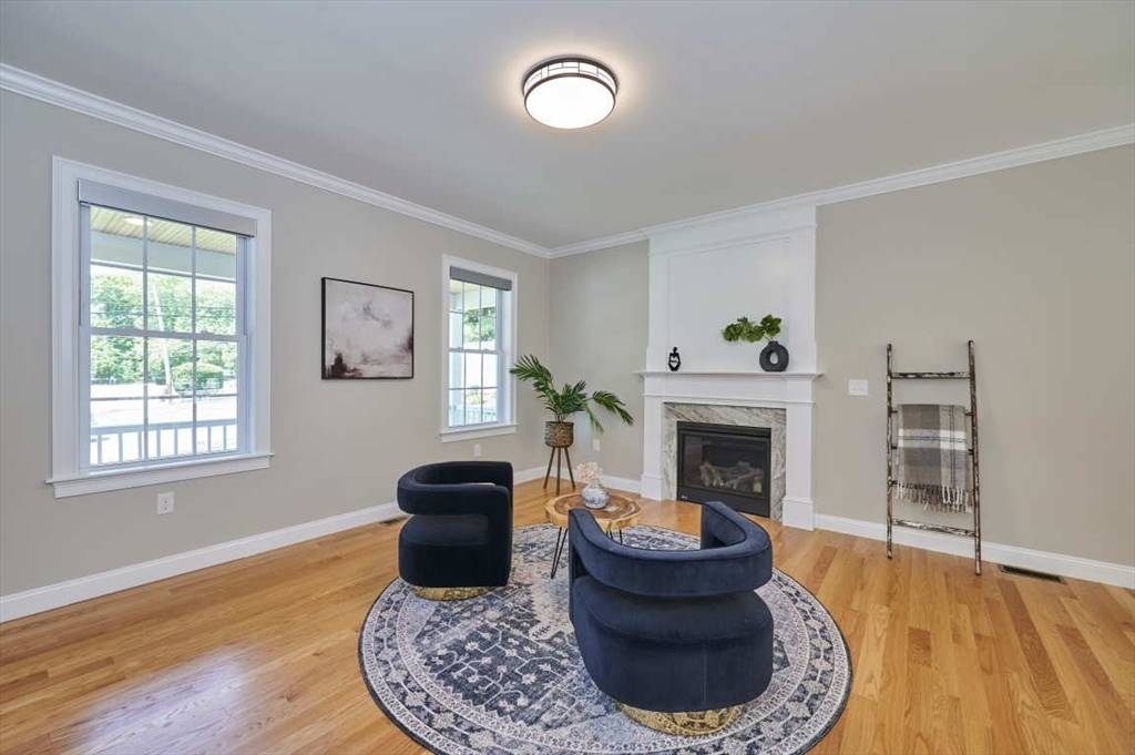 60 Peach Orchard Road Burlington, MA 01803 - Photo 7 of 42 a living room with furniture a fireplace and a window