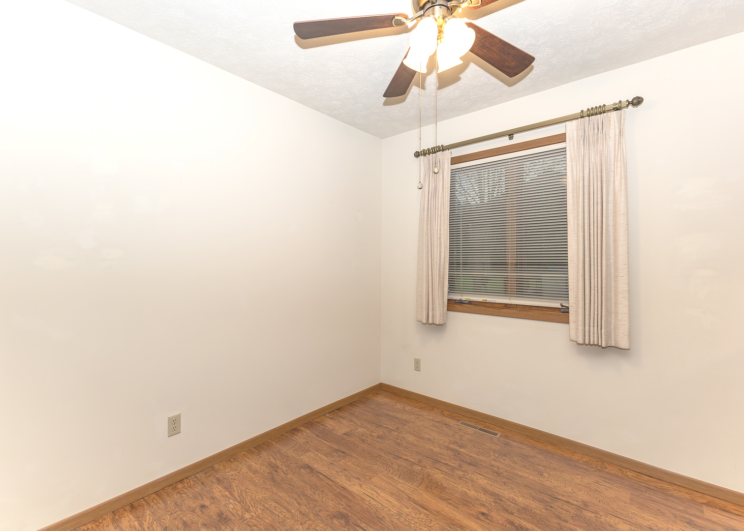4237 26th Avenue, Unit 1 Moline, IL 61265 - Photo 7 of 18 an empty room with a window and a ceiling fan
