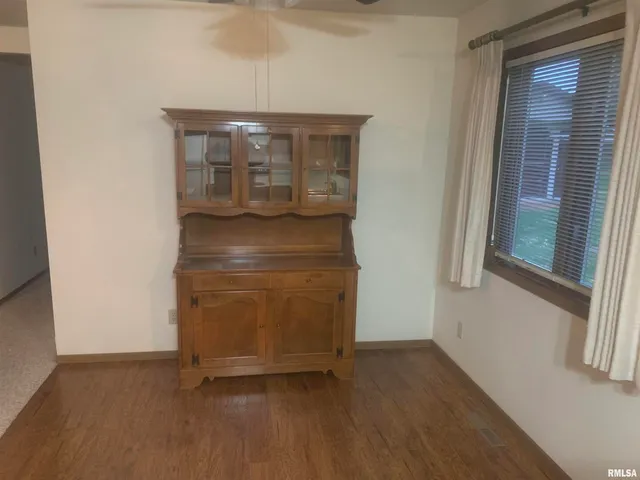 a water heater cabinet with wooden floor