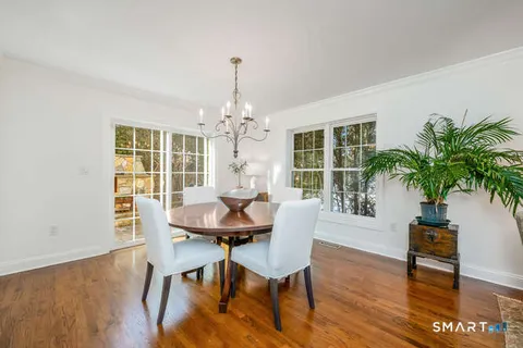 a view of a dining room with furniture window and wooden floor