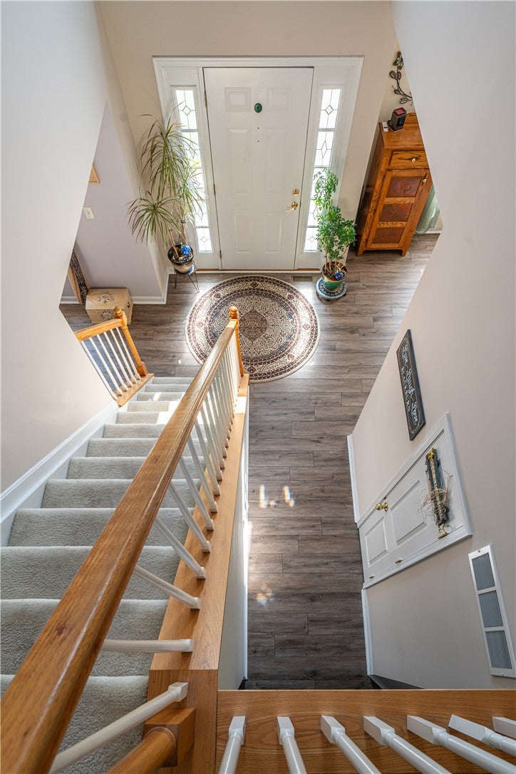 10765 Stone Ridge Way Harrison, OH 45030 - Photo 37 of 68 A welcoming entry features durable wood flooring and a classic white door with decorative glass panels.