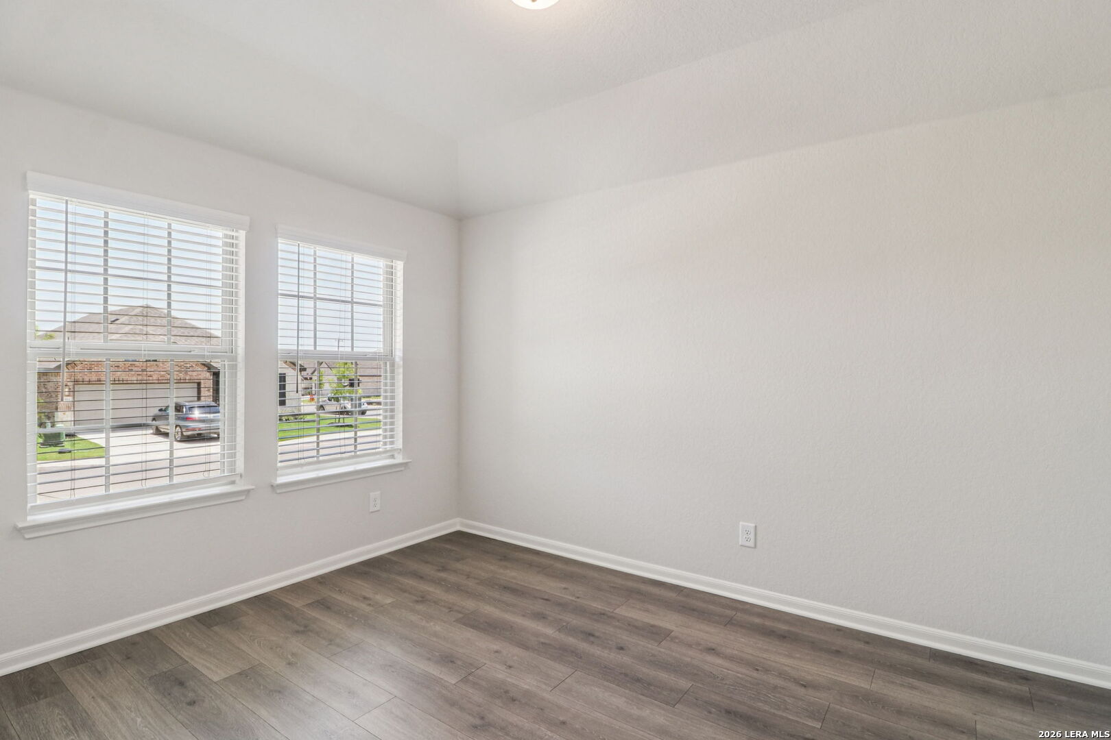 9909 Paladin Ridge San Antonio, TX 78254 - Photo 16 of 41 an empty room with wooden floor and windows