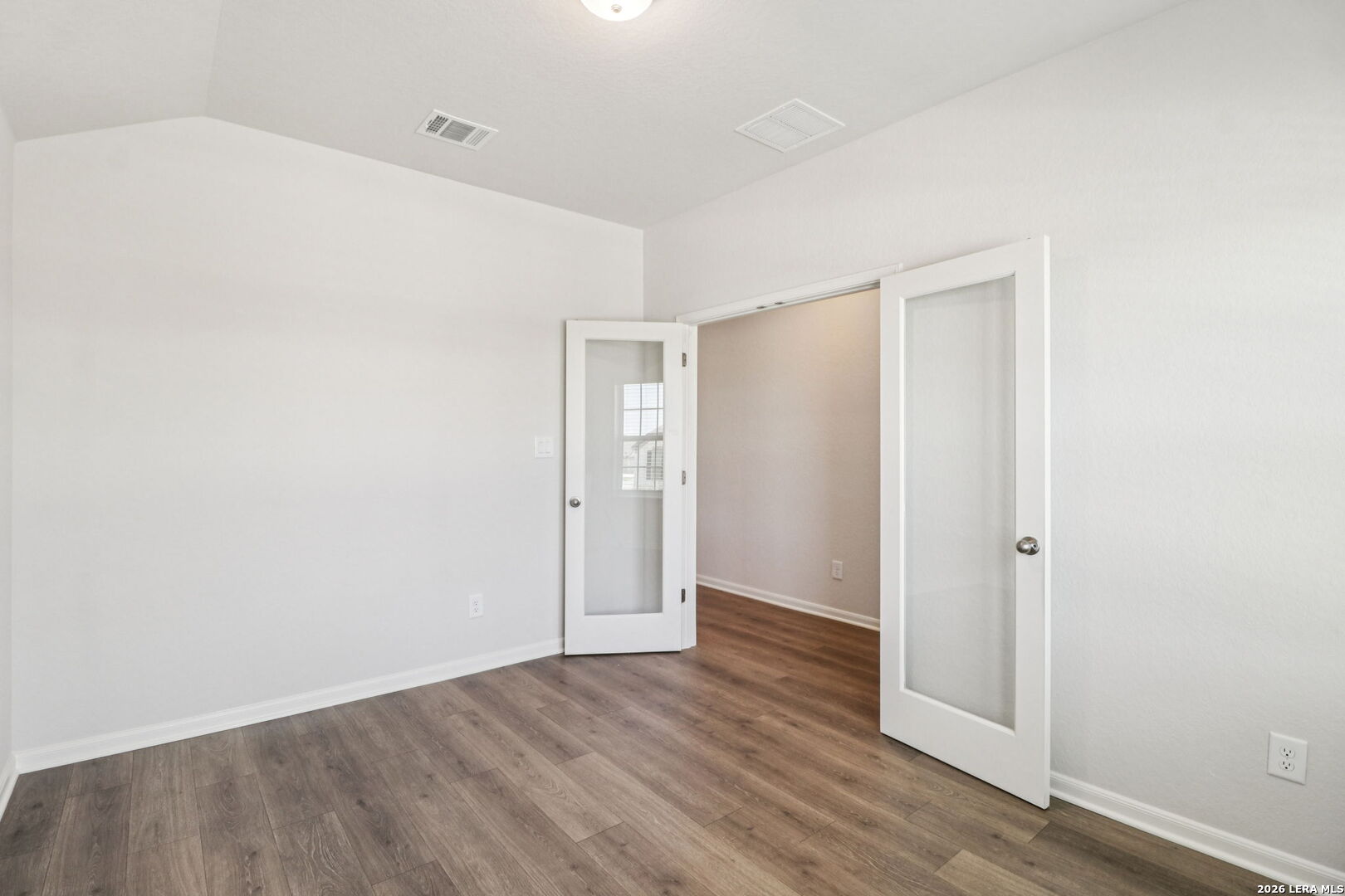 9909 Paladin Ridge San Antonio, TX 78254 - Photo 17 of 41 a view of an empty room with wooden floor