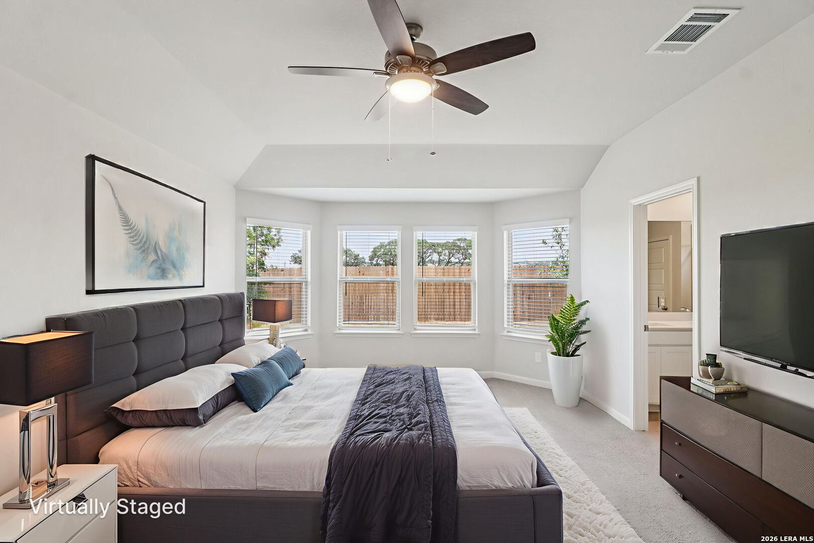 9909 Paladin Ridge San Antonio, TX 78254 - Photo 20 of 41 a bedroom with a bed and a flat screen tv